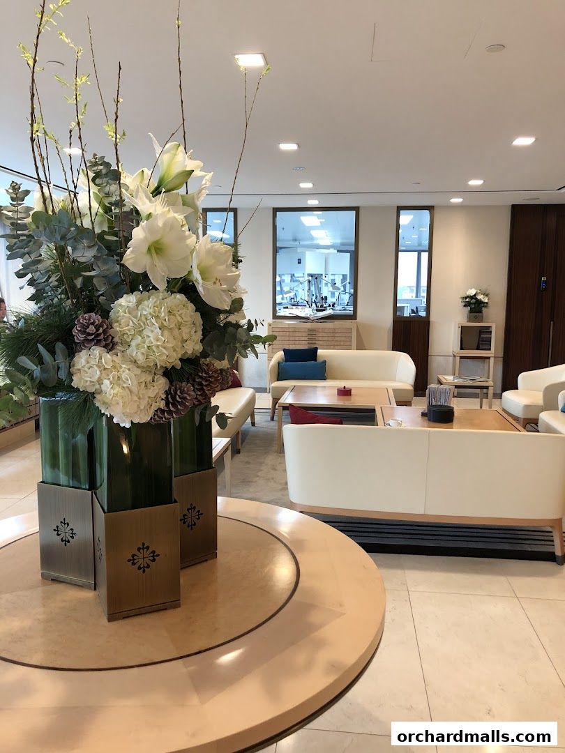 Elegant interior of Patek Philippe Singapore Customer Service Centre with floral arrangements and seating.
