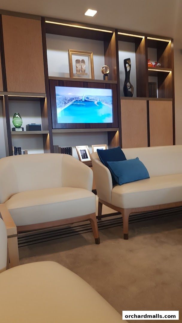 Interior of a luxury lounge area with comfortable seating and decorative shelves.