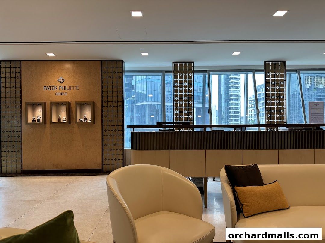 Interior of a Patek Philippe customer service center with watches displayed and city views.