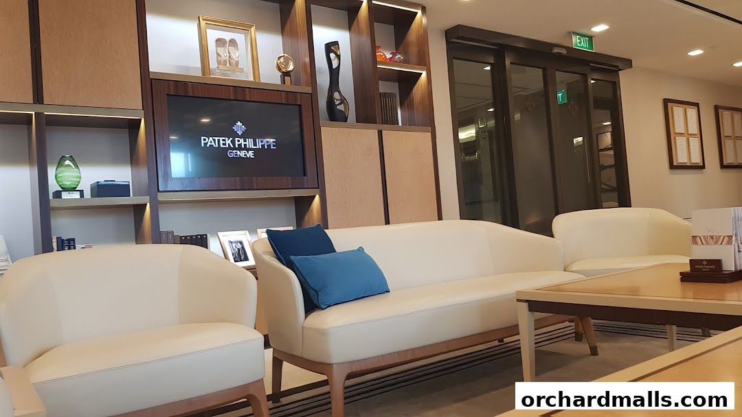 Interior of a Patek Philippe customer service center with seating and display shelves.