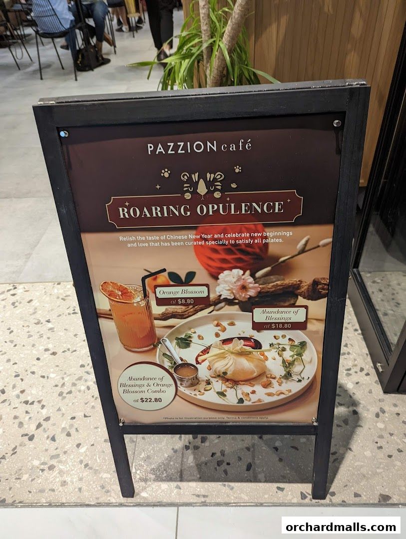 A Pazzion Cafe A-frame sign advertising Chinese New Year specials with food and drink.