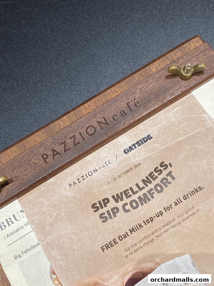 A menu from Pazzion Cafe featuring a special offer for oat milk top-ups.