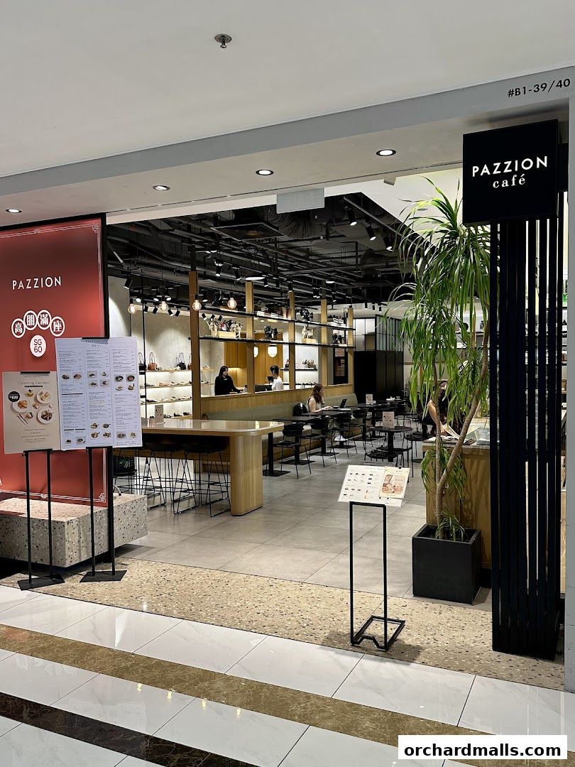 The entrance to Pazzion Cafe, featuring a modern interior with seating and displays.