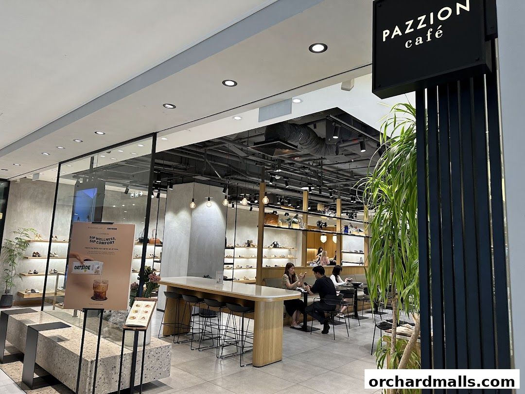 Interior view of PAZZION cafe and shoe store with seating and merchandise displays.