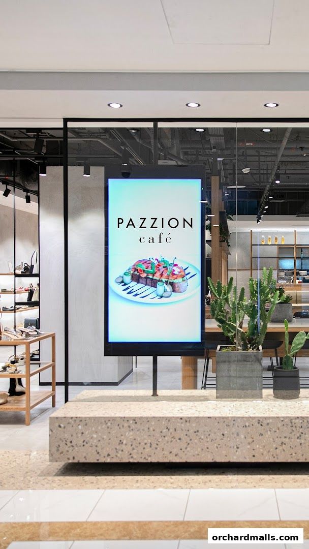 A digital display shows the PAZZION cafe logo and a picture of a gourmet dish.