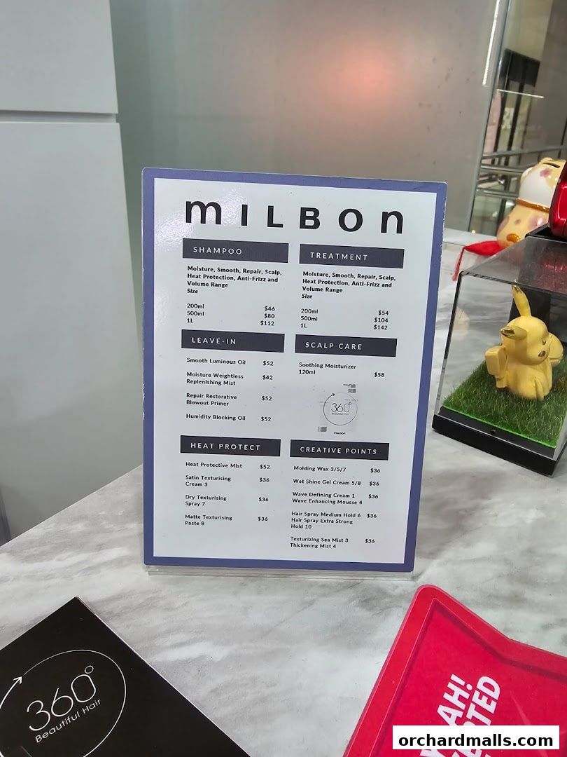 A Milbon product menu displaying shampoos, treatments, leave-in, scalp care, heat protect, and creative styling products.