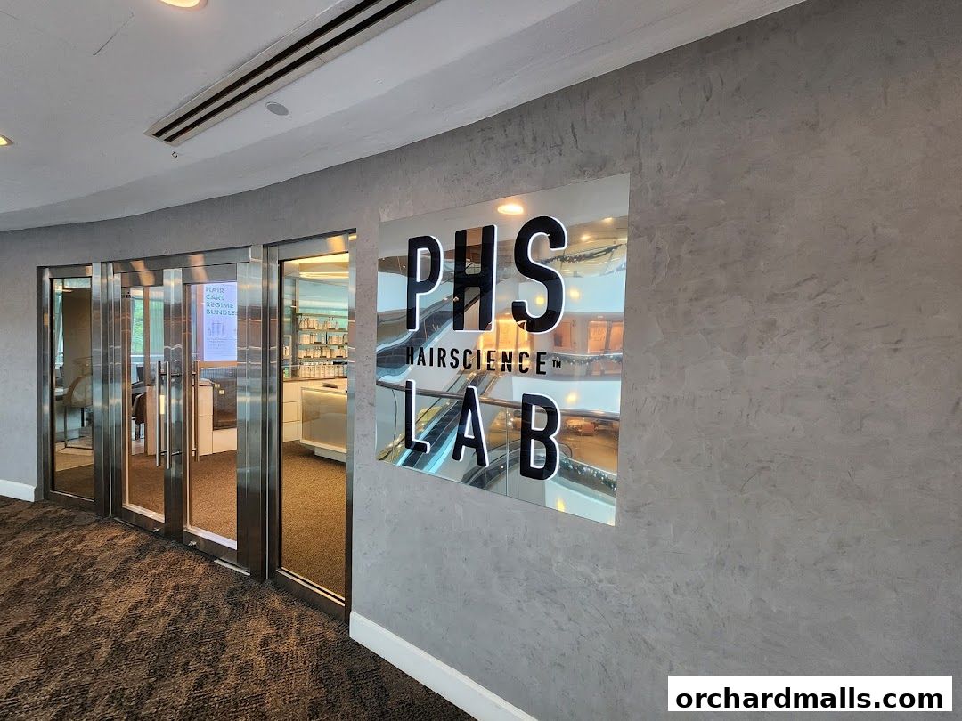 Entrance to PHS HAIRSCIENCE LAB with a large reflective sign and glass doors.