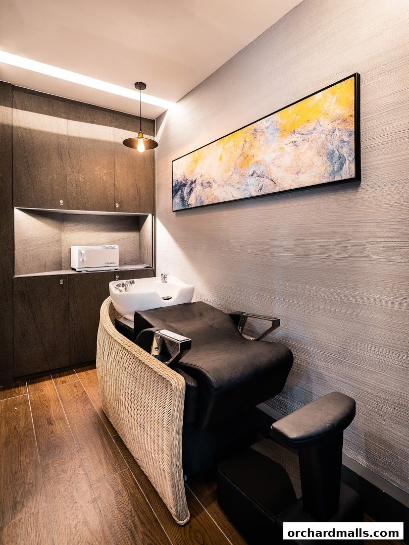 A modern hair washing station with a comfortable chair and a sleek sink.