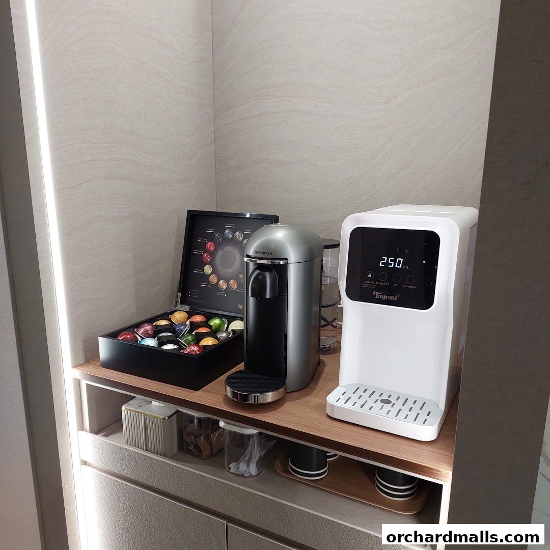 A Nespresso coffee machine with a selection of capsules and a water dispenser.