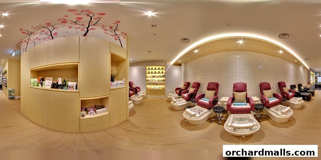Interior of a nail spa with pedicure chairs, shelves of products, and cherry blossom decor.