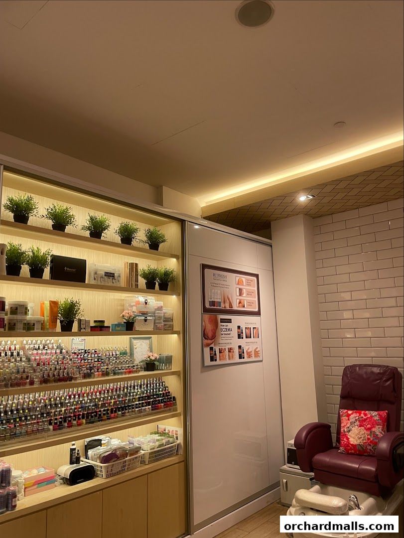 Interior of a nail spa with shelves of nail polish, products, and a pedicure chair.
