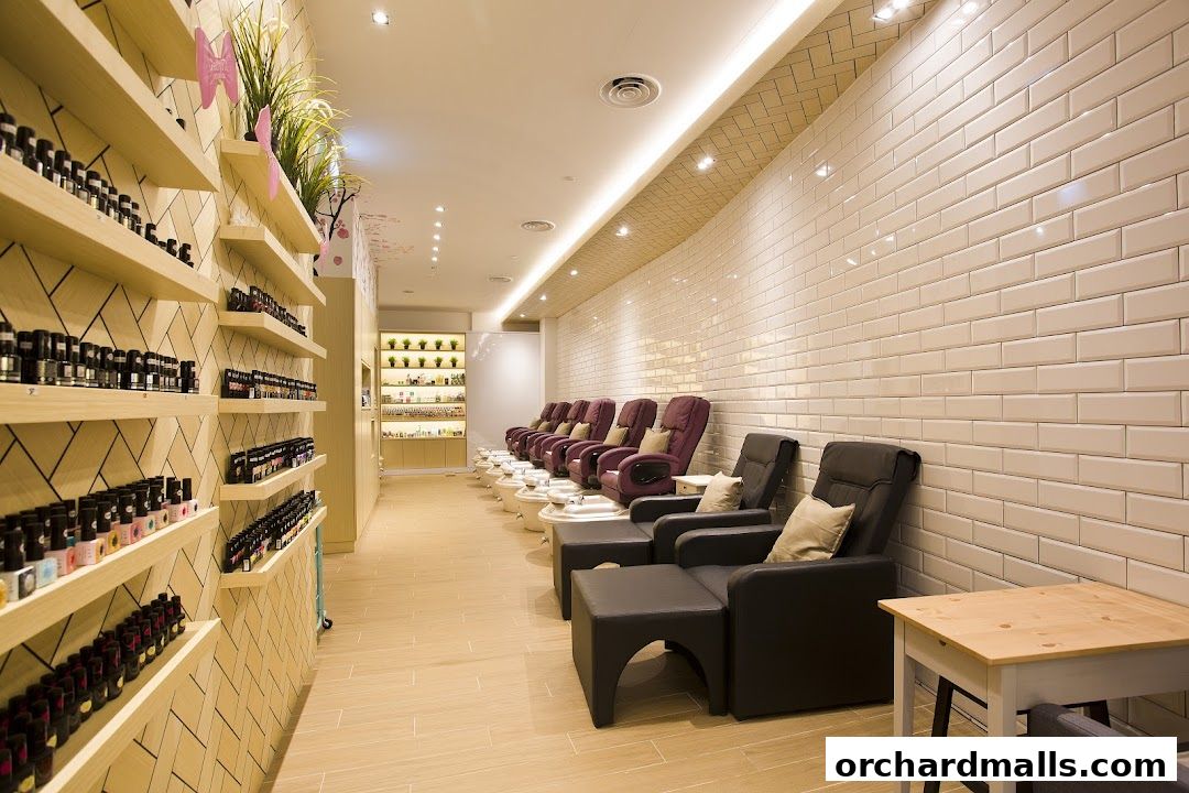Interior of a nail spa with shelves of nail polish and pedicure chairs.
