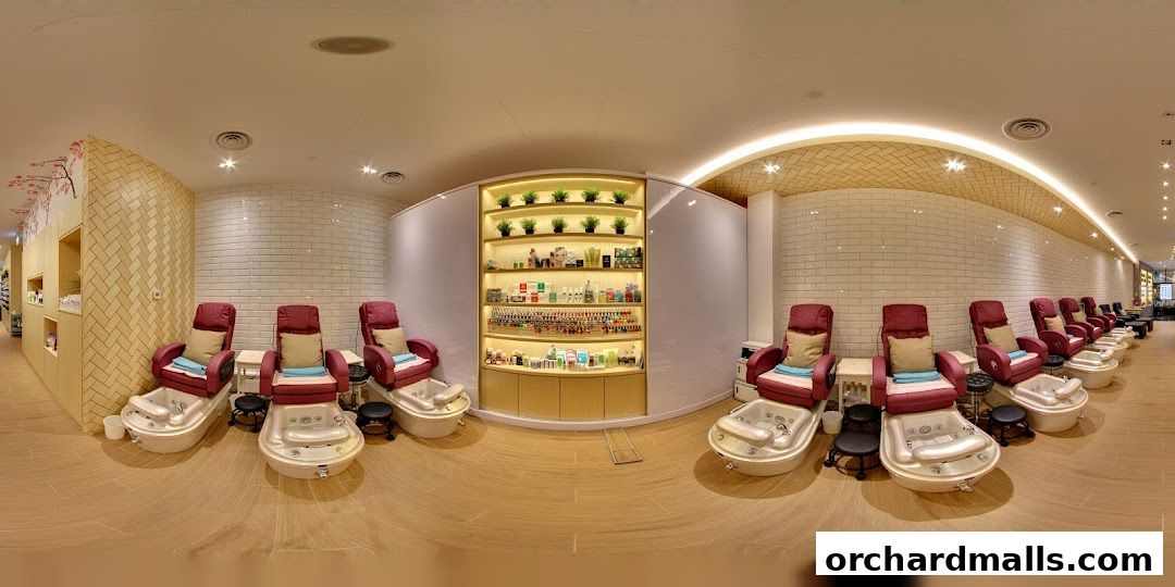 Interior view of a nail spa with multiple pedicure chairs and shelves stocked with nail polish.