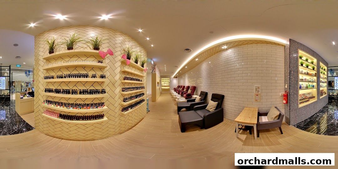 Interior of a modern nail spa with shelves of nail polish and comfortable seating.