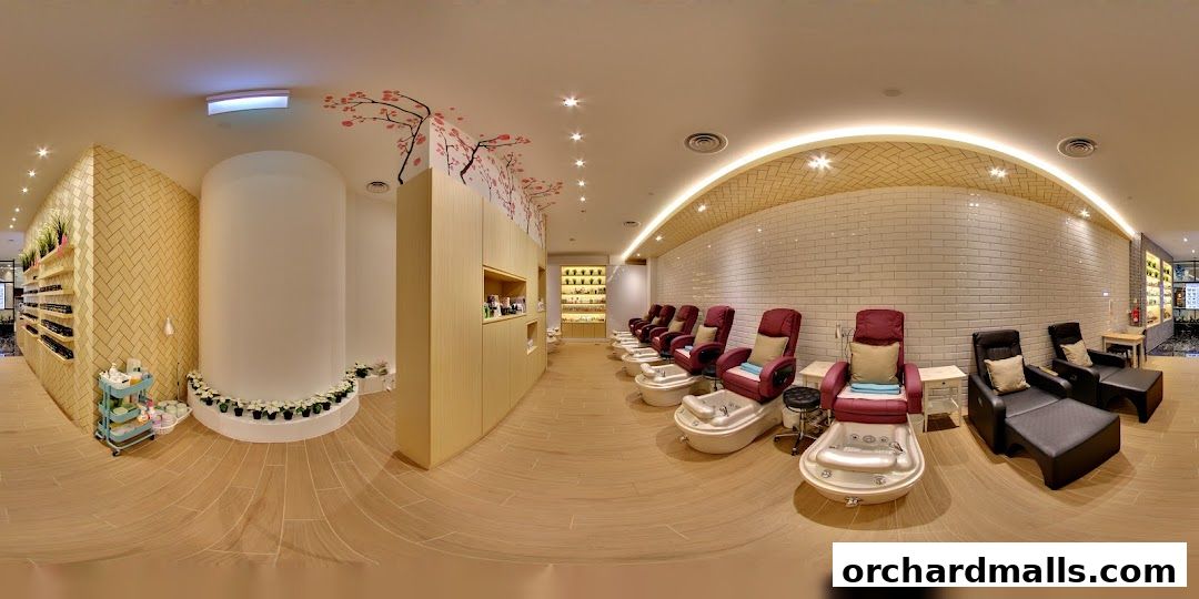 Interior of a nail spa with pedicure chairs, manicure stations, and shelves of nail polish.