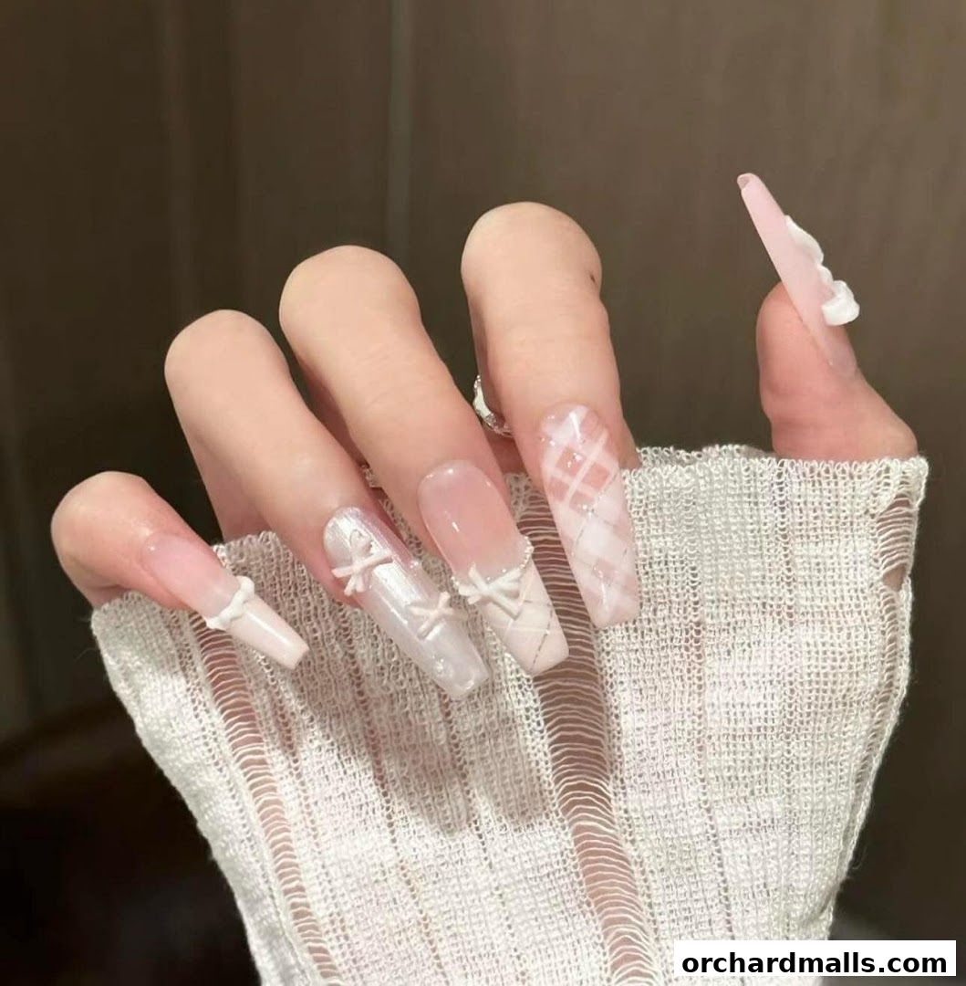 A close-up of a hand with long, elegant coffin-shaped nails featuring intricate designs.