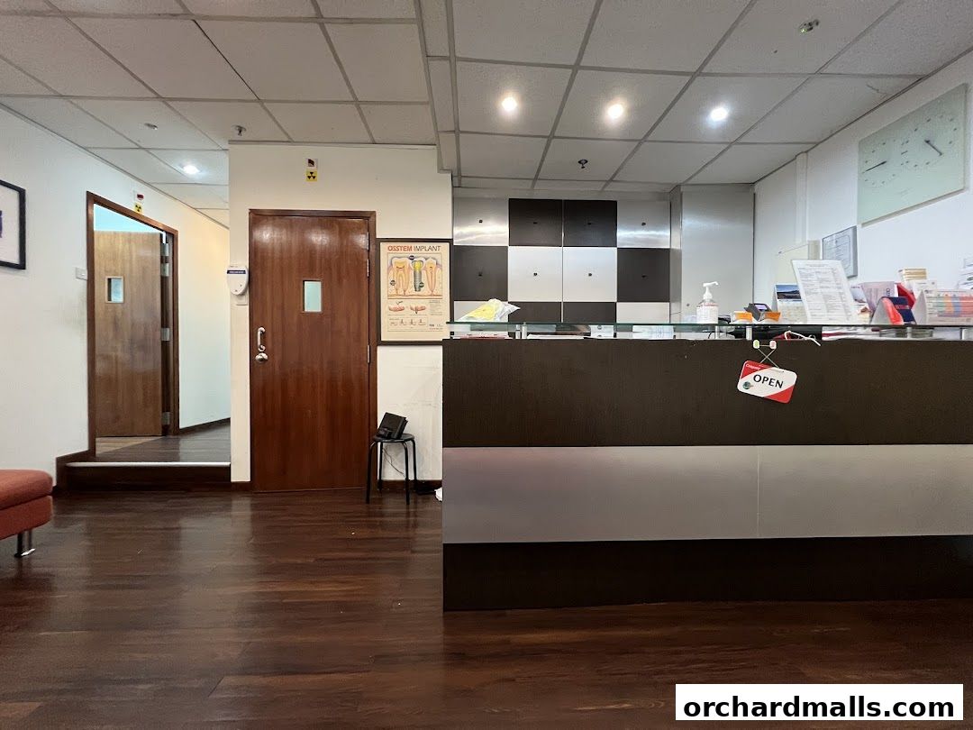 Interior view of Pinnacle Dental Group Pte Ltd reception area with doors and a counter.