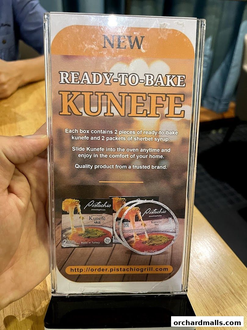 A sign advertising ready-to-bake Kunefe from Pistachio Middle Eastern Mediterranean Grill.