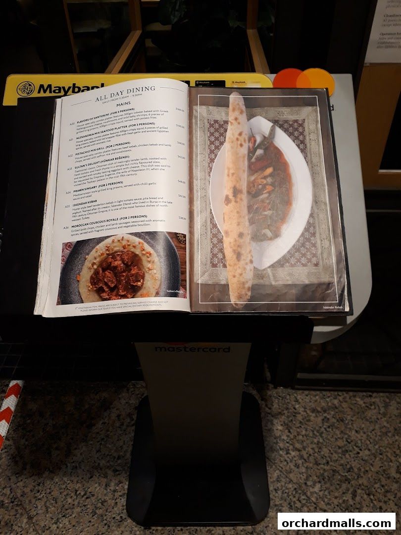 A menu from Pistachio Middle Eastern Mediterranean Grill with food images.