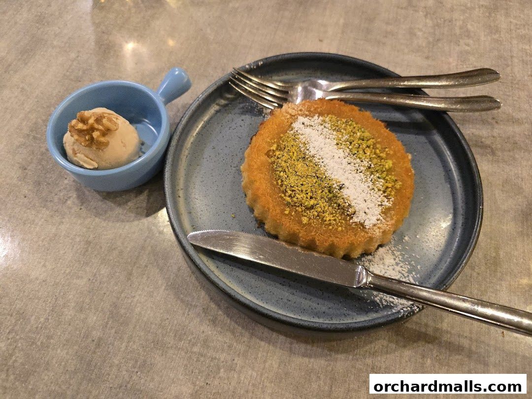 A delicious dessert with ice cream and nuts on a plate.