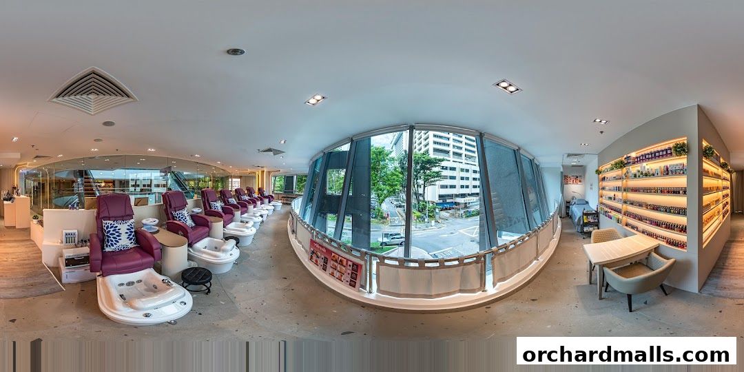Interior of a modern nail spa with pedicure chairs, product shelves, and a reception area.