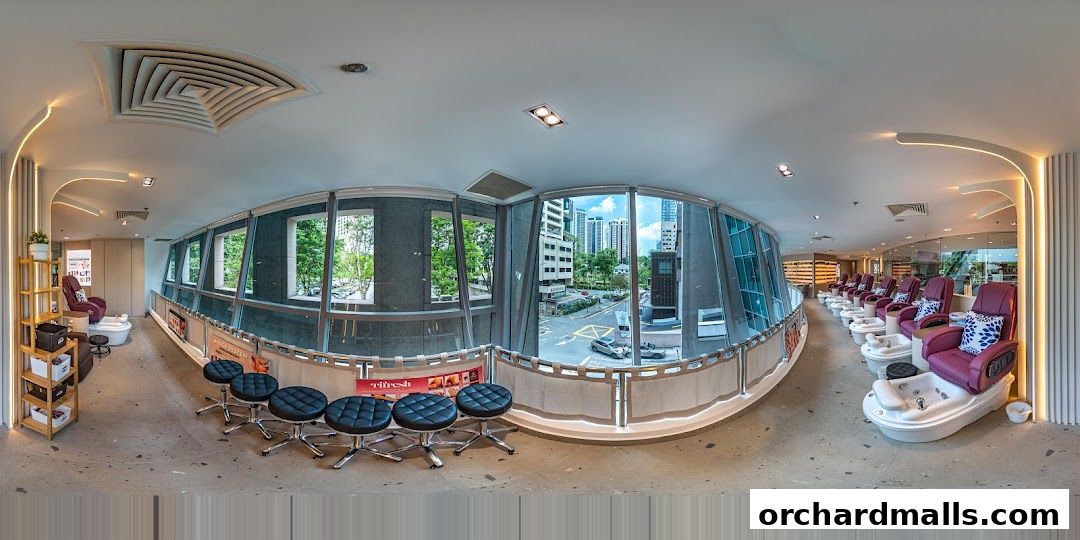 Interior of a modern nail spa with pedicure chairs and manicure stations.