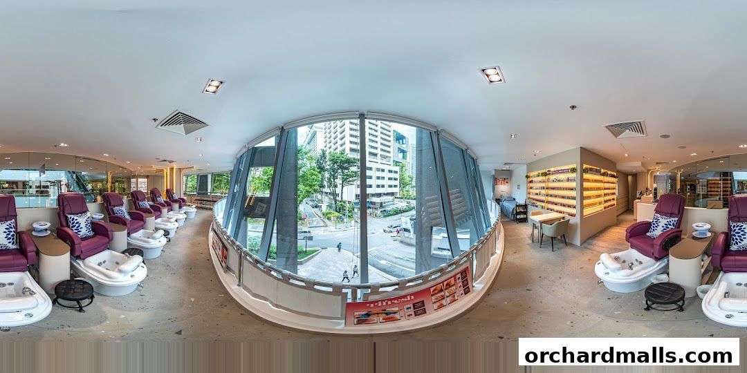 Interior of a nail spa with pedicure chairs, nail polish display, and city view.