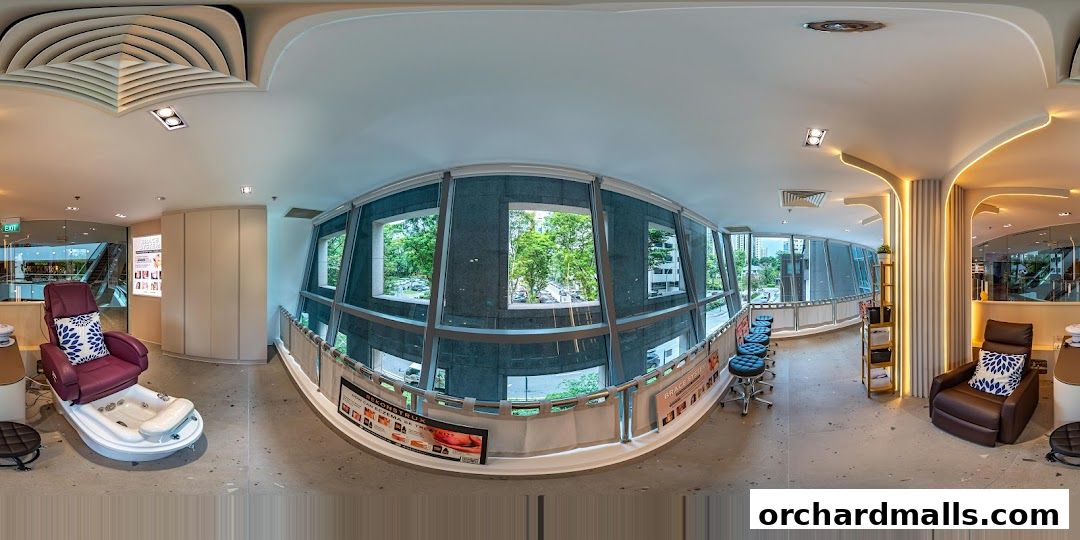 Interior of a modern nail spa with pedicure chairs, manicure stations, and large windows.