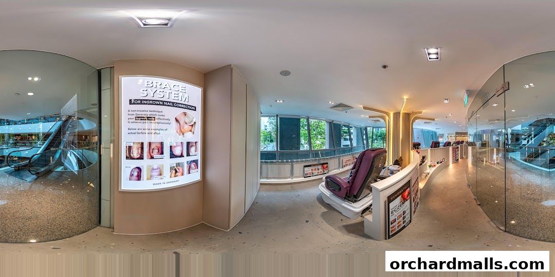 Interior of a nail spa with massage chairs and a display for ingrown nail correction.