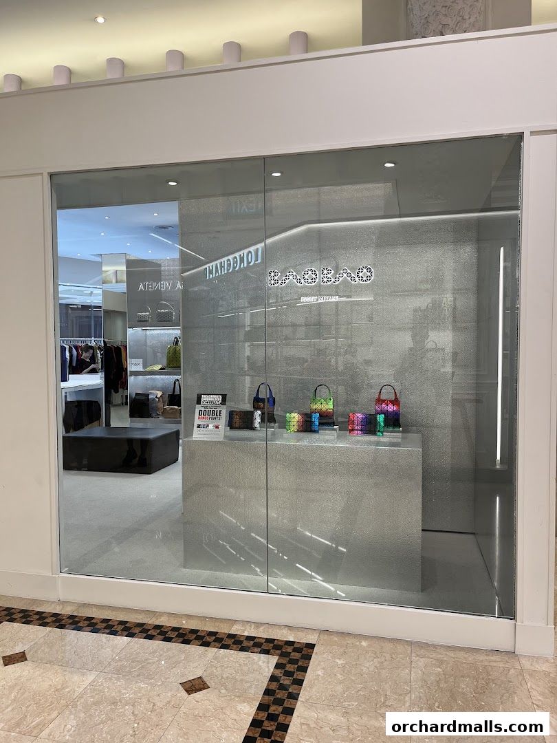 A modern shop front with a display of colorful geometric bags and accessories.