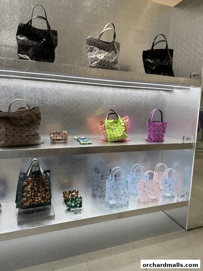 Display of geometric patterned bags in various colors and sizes on shelves.