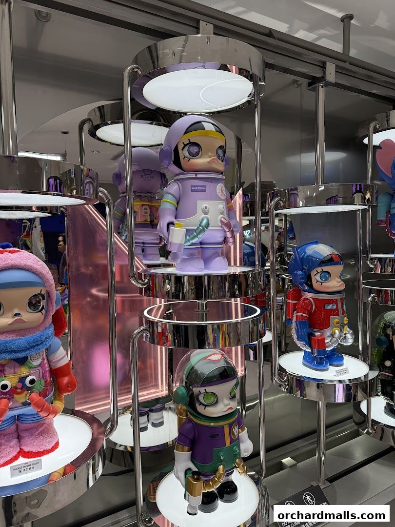Display of collectible designer toys in a retail store, featuring astronaut-themed figures.