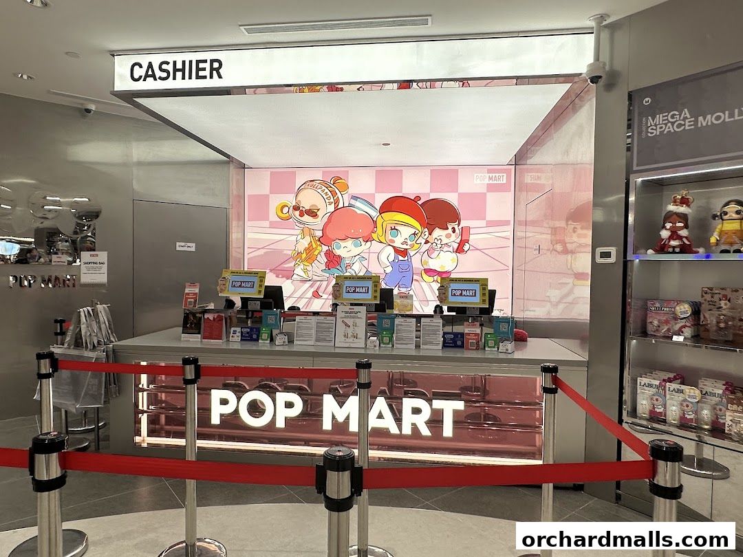 The cashier counter of a POP MART store with colorful character displays and merchandise.