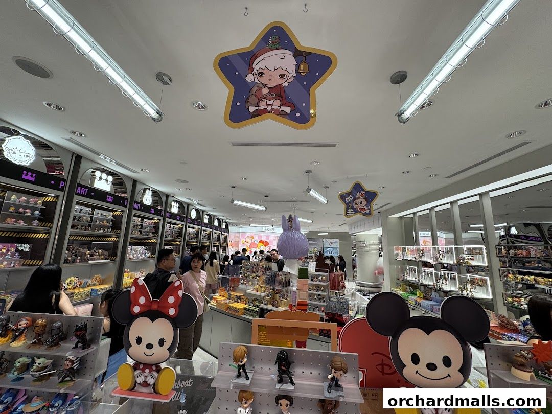 Interior of a POP MART store filled with collectible toys and figurines, including large Mickey and Minnie Mouse figures.