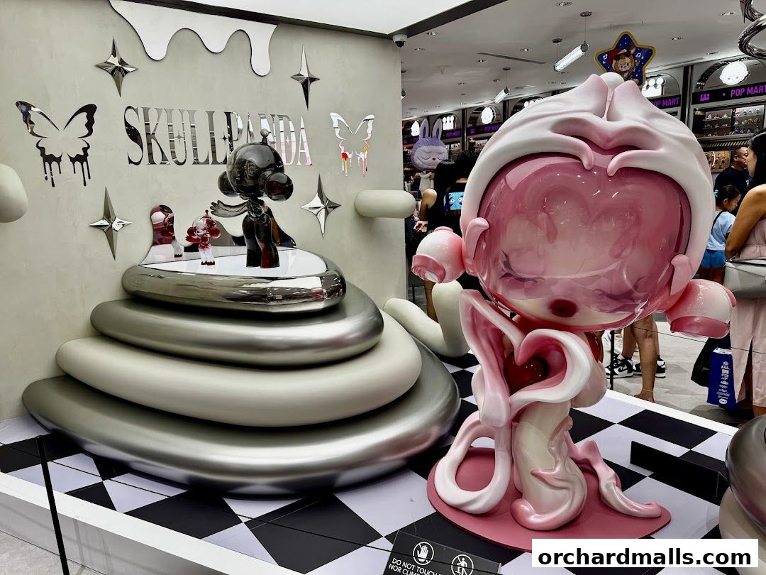 POP MART Ion Orchard shop interior featuring large, artistic collectible figures and displays.