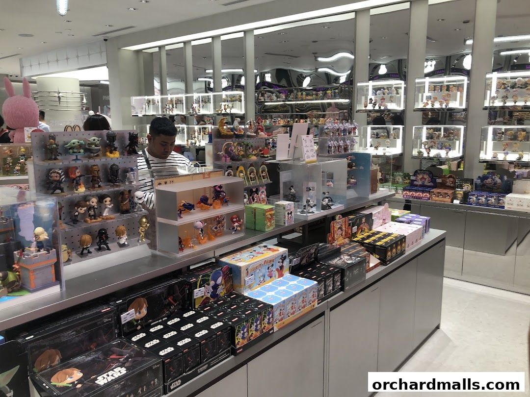 A store interior filled with collectible figurines and merchandise, with a customer browsing.