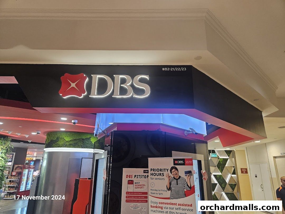 The exterior of a DBS bank branch with prominent signage and promotional posters.