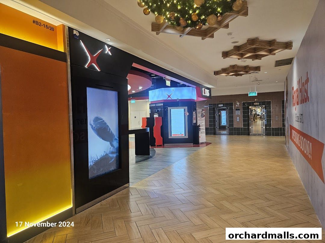Exterior view of a POSB bank branch with digital displays and mall corridor.