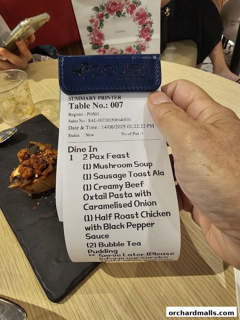 A receipt from Poulet Brasserie showing a 2 Pax Feast order with various dishes and drinks.