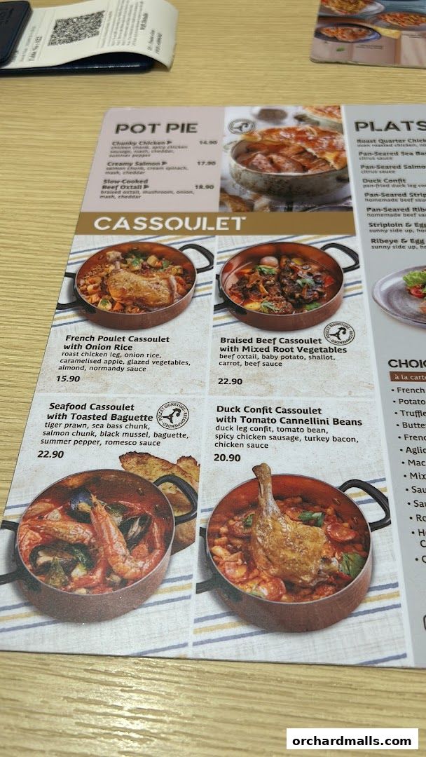 A menu featuring various cassoulet dishes and pot pies with appetizing images.
