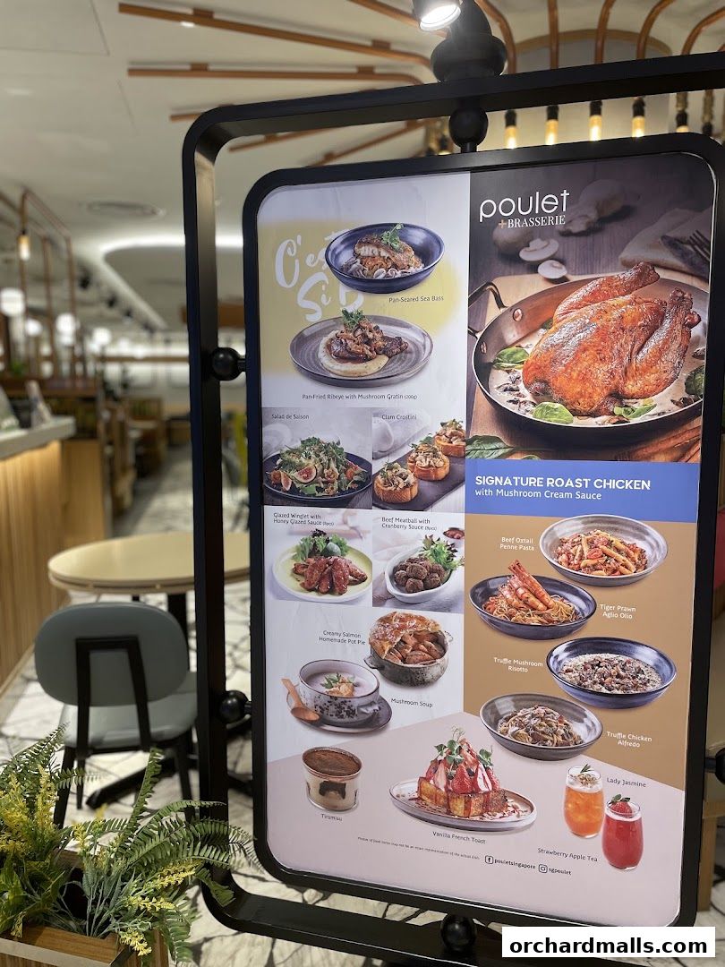 A menu board displaying various dishes from Poulet + Brasserie, including signature roast chicken.
