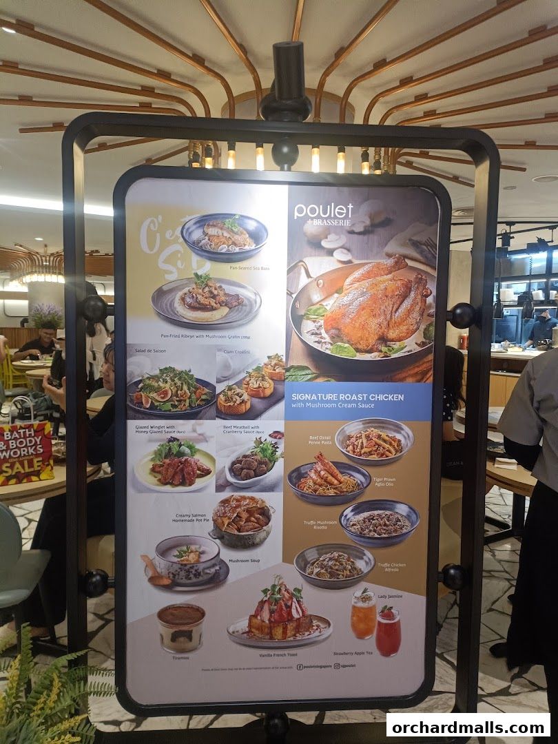 A display board showcasing various dishes and drinks offered at Poulet + Brasserie.