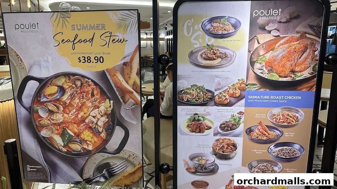 A display of Poulet + Brasserie's menu items, featuring seafood stew and roast chicken.