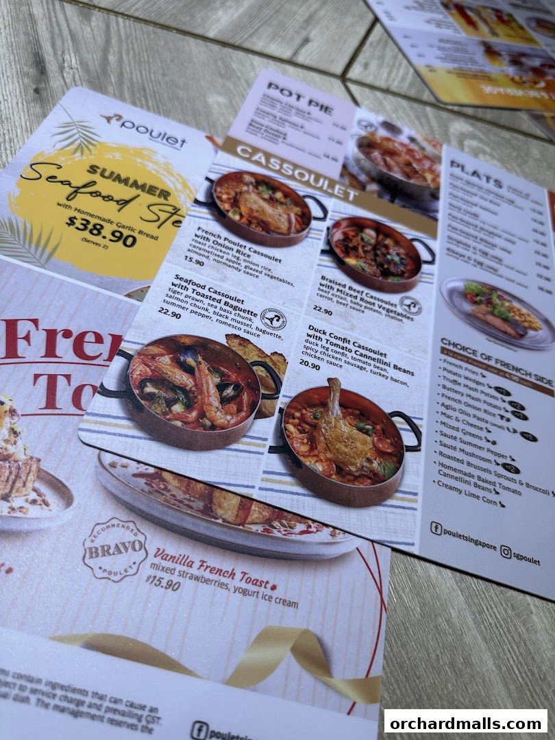 A close-up view of a menu from Poulet Brasserie, showcasing various French dishes.