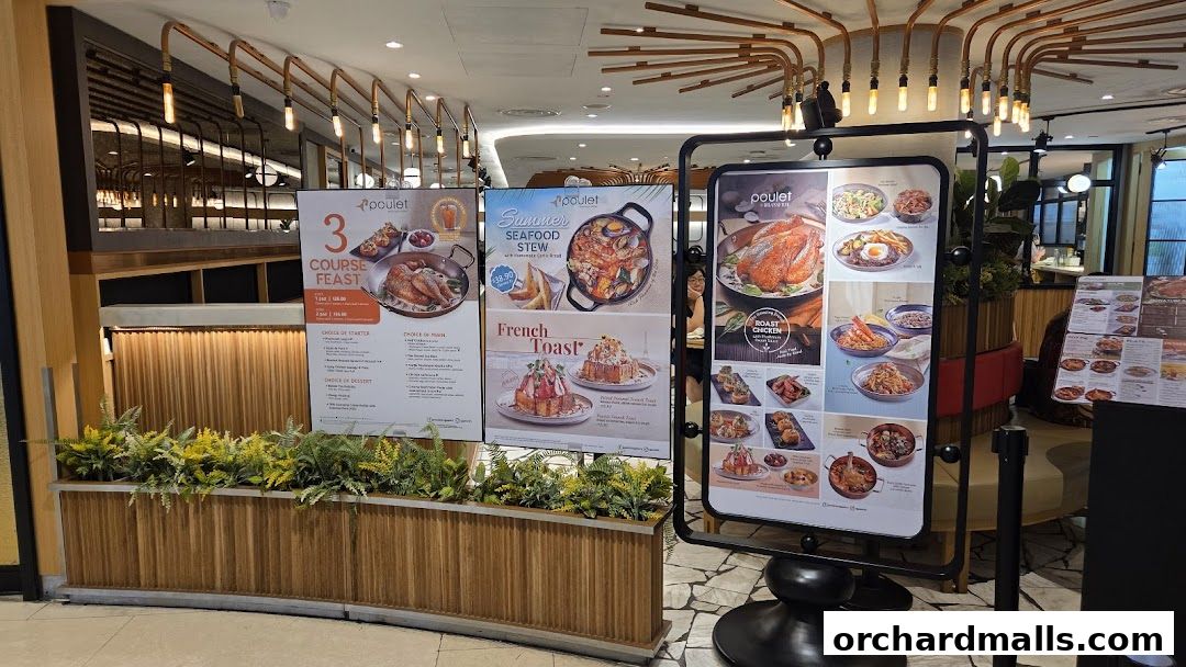 A display of Poulet Brasserie's menu items and promotions outside the restaurant.
