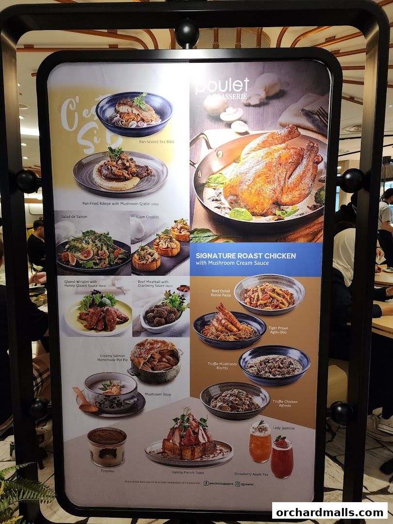 A menu board displaying various dishes from Poulet Brasserie, featuring roast chicken and other European-inspired meals.