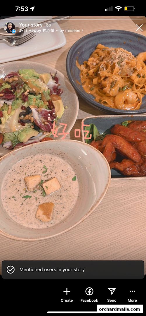 A table laden with delicious dishes including soup, salad, pasta, and chicken wings.