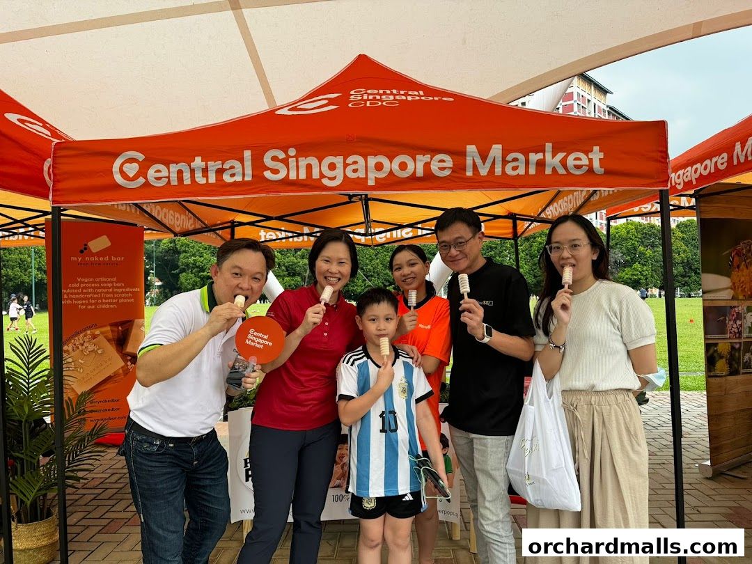 A group of people enjoying popsicles under a Central Singapore Market tent.