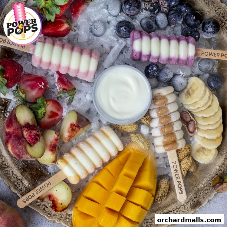 A delightful assortment of fresh fruit and popsicles on a decorative tray.