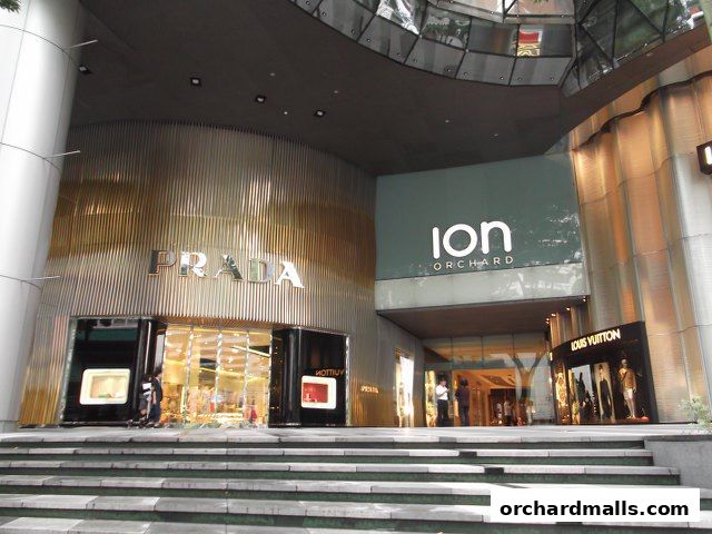 The entrance of the Prada store at ION Orchard, Singapore, with a Louis Vuitton store nearby.